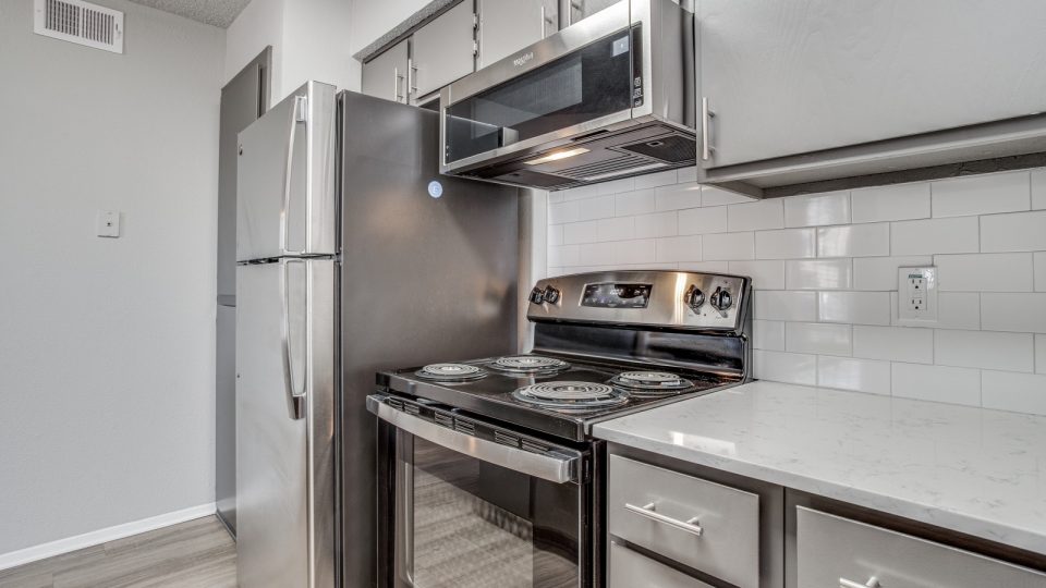 a kitchen with stainless steel appliances and a microwave at The Westley
