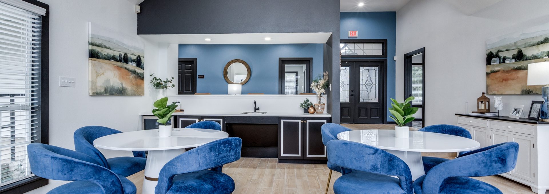 a kitchen with blue chairs and a dining table at The Westley