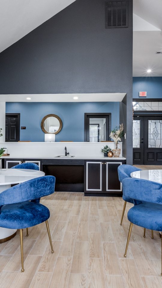 a kitchen with blue chairs and a dining table at The Westley